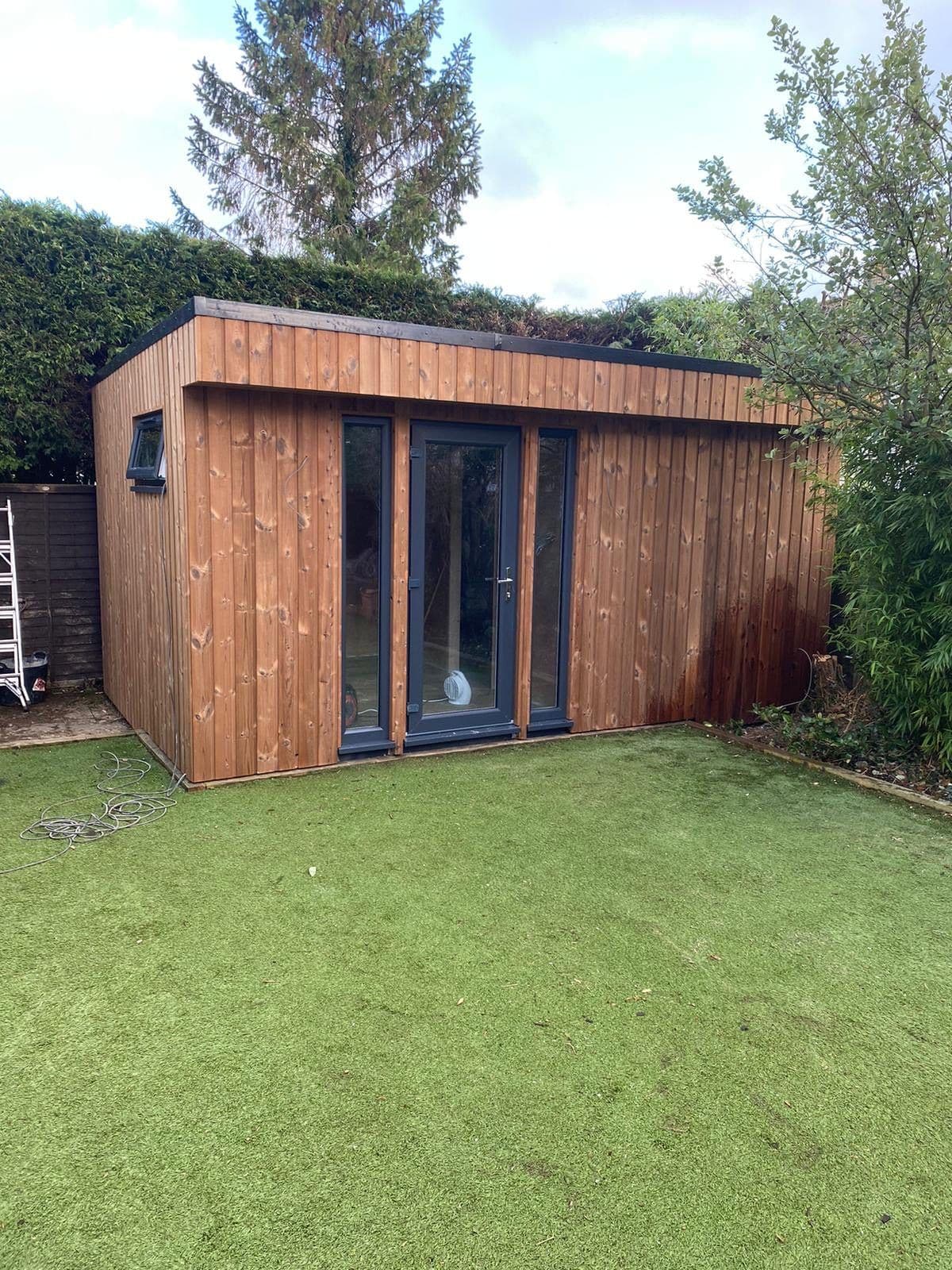 Timber-clad garden room with glazed doors