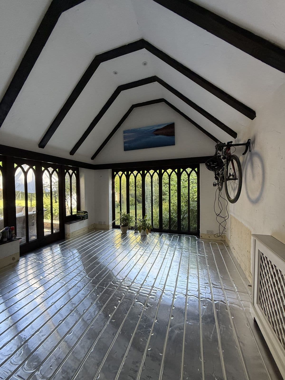 Vaulted room with exposed beams and new flooring